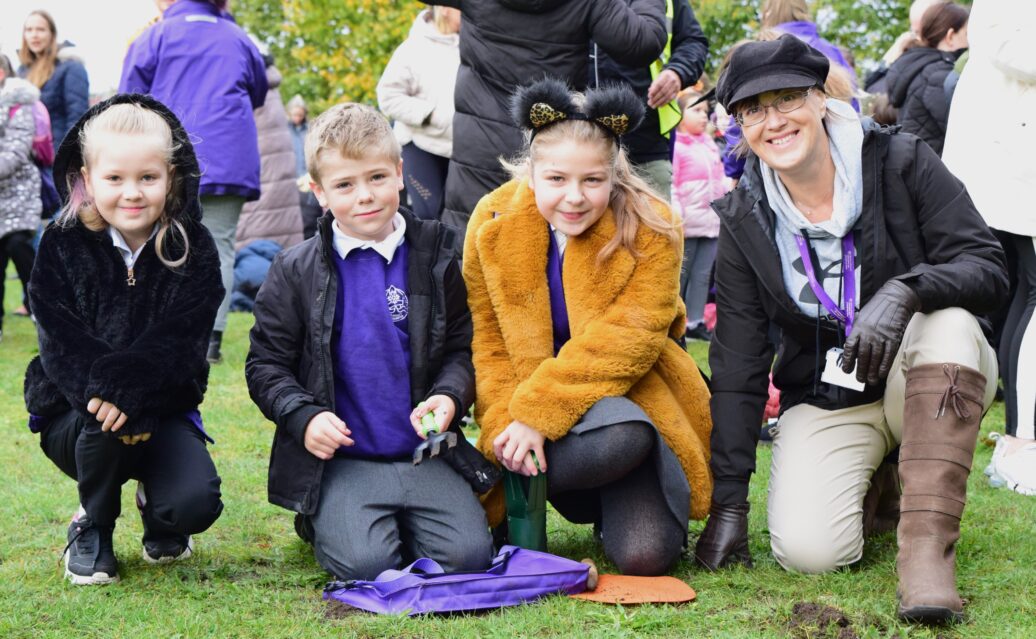 The head teacher Mrs Ratcliffe gets dirty planting bulbs with the children