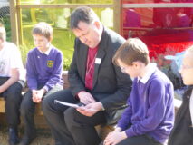 Bishop Graham reading about the plants